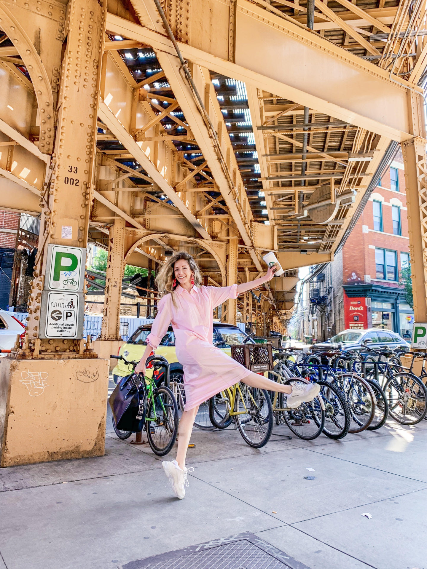 a woman wearing a dress and the best fashion sneakers for fall